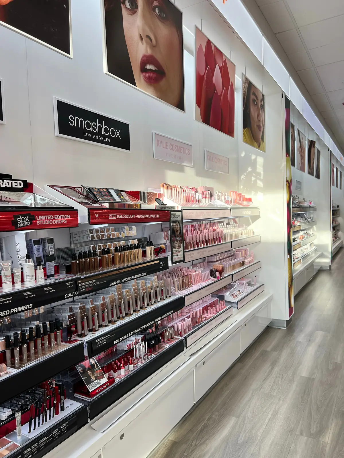 A wall of make-up products and testers in a beauty store