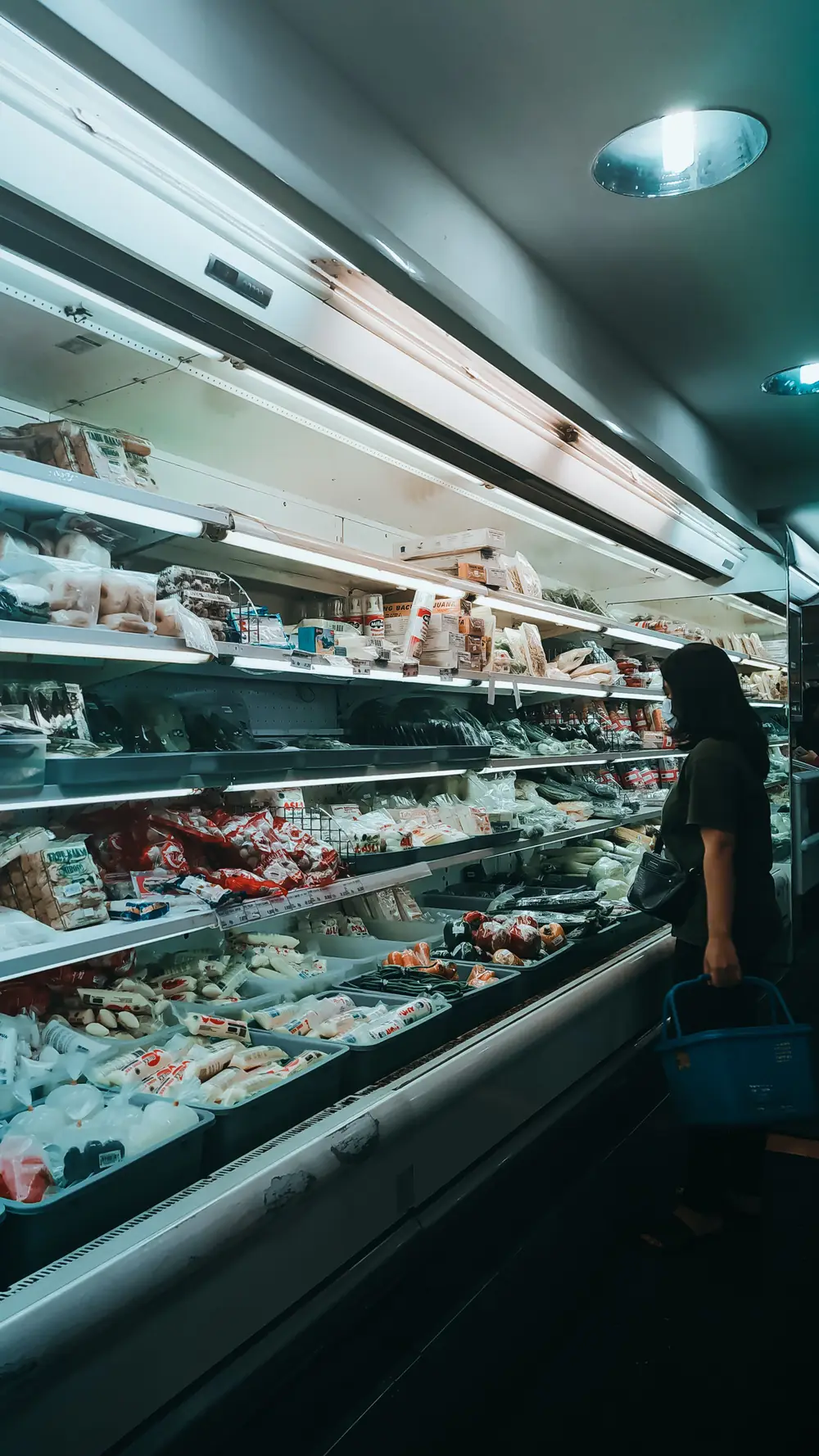 A supermarket aisle lined with chilled and packaged goods